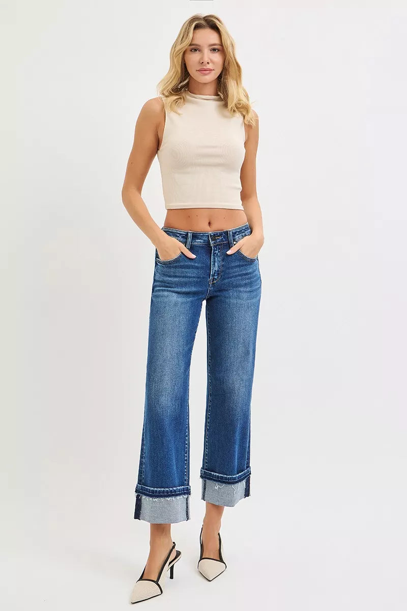 Mid-rise ankle straight jeans featuring cuffed hem and front pockets, dark denim