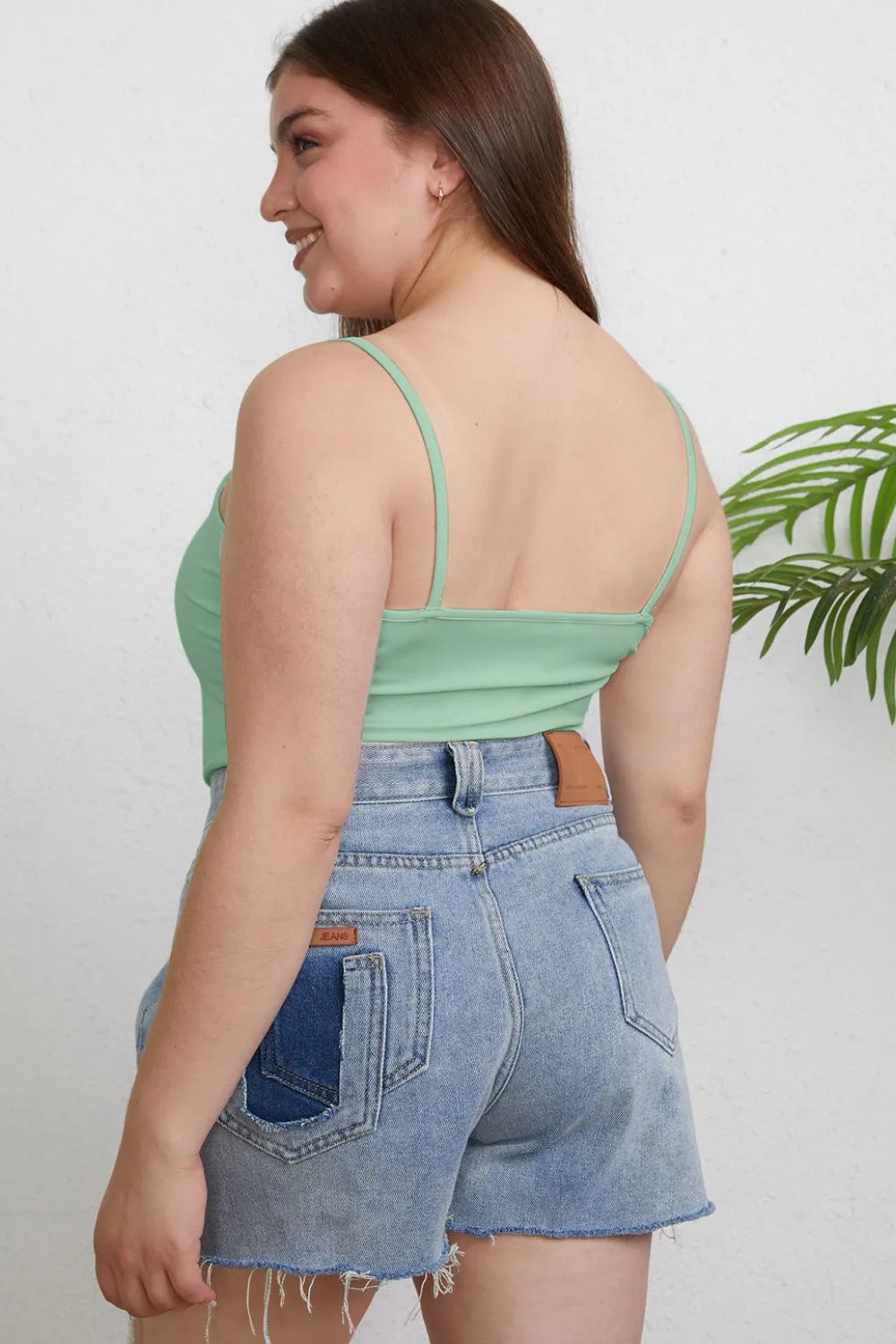 Light green fitted cami back with spaghetti straps and round neckline