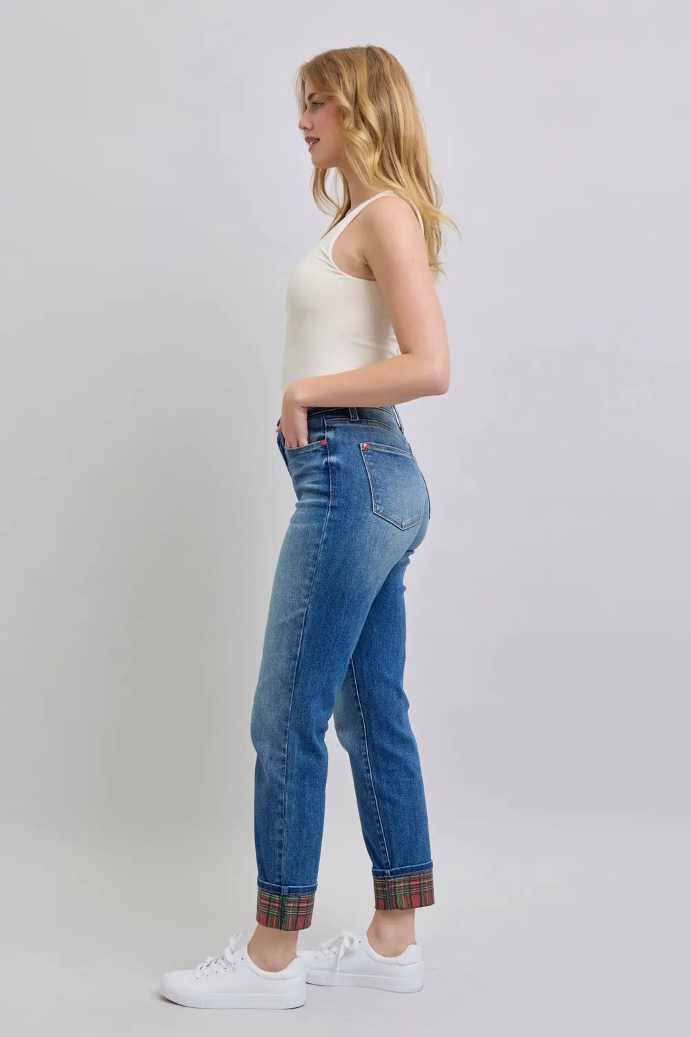 Medium wash jeans profile view with plaid cuffs at the hem