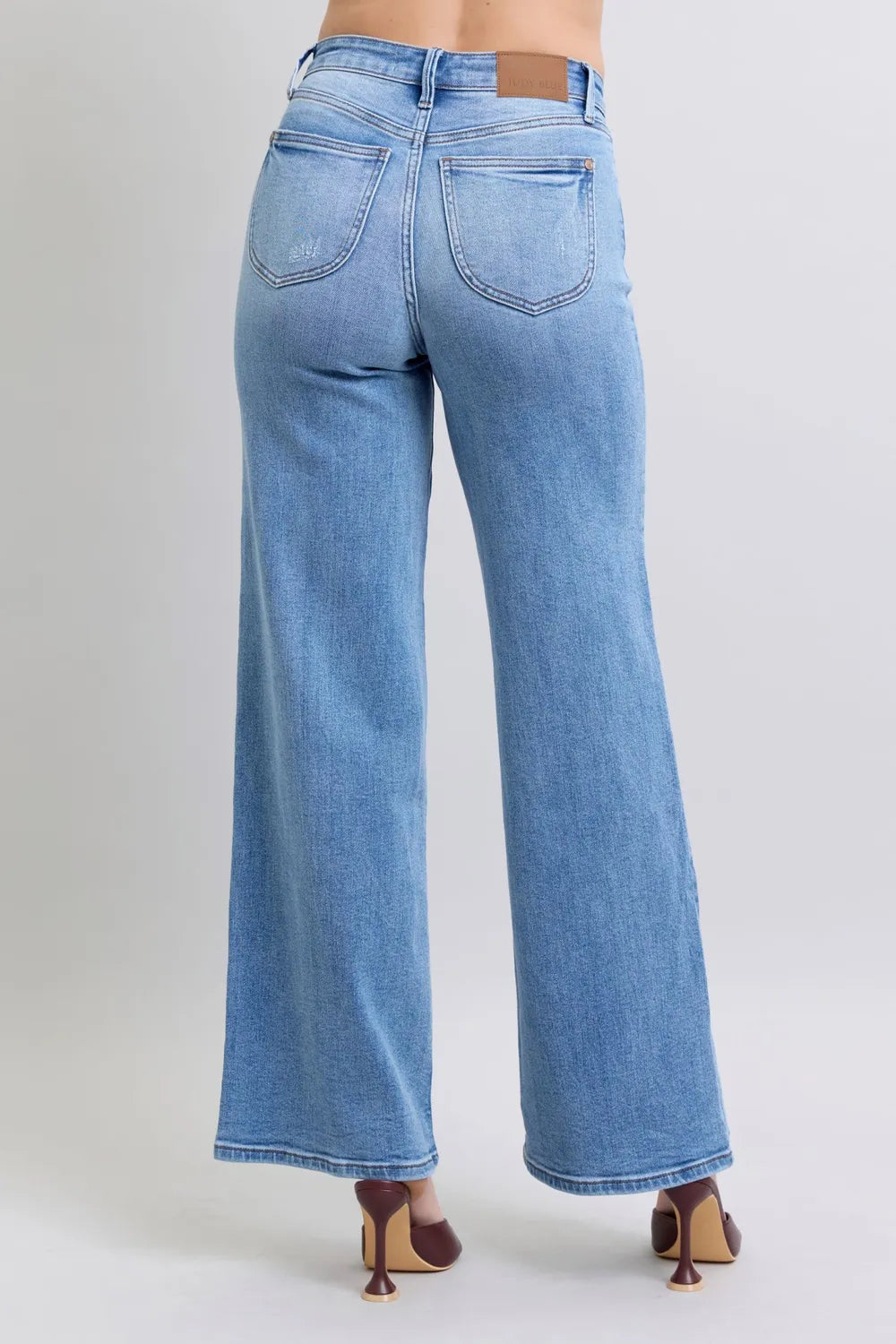 Medium-wash wide-leg jeans, rear view with two back pockets and yoke stitching