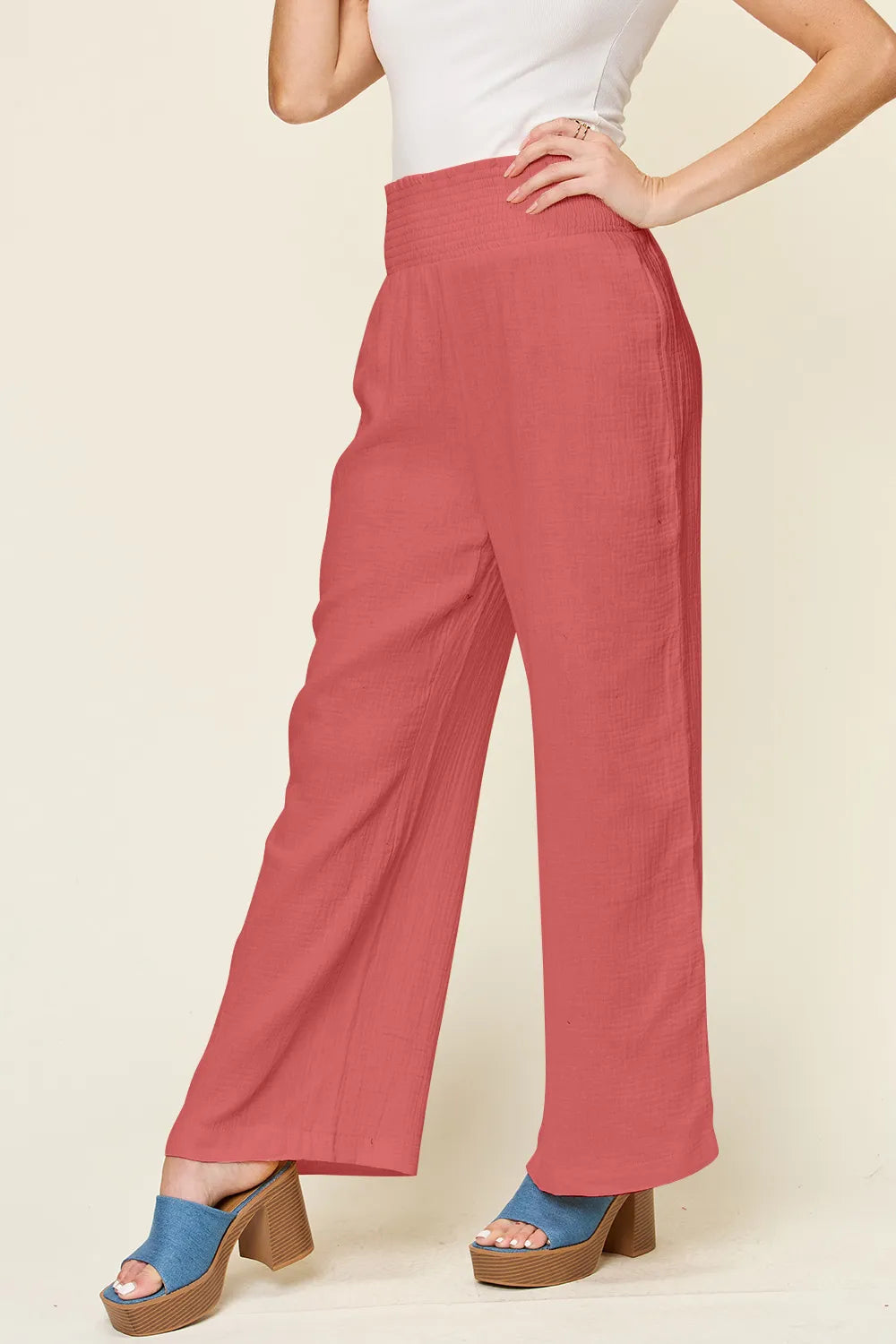 Hot pink textured wide-leg pants with smocked waistband