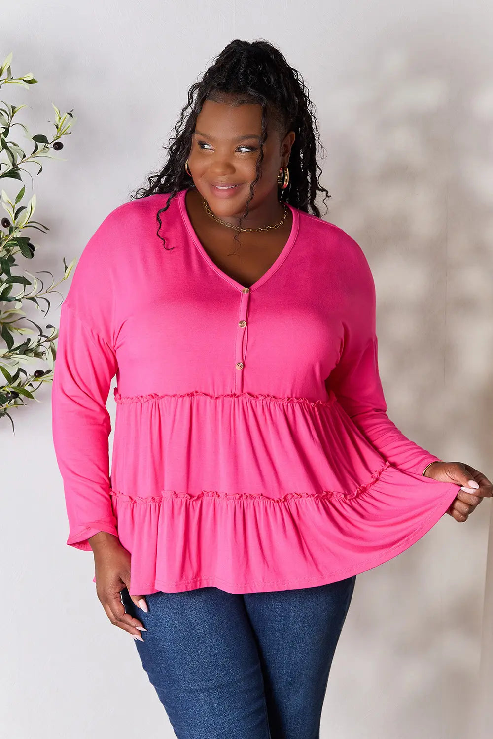 Hot pink tiered ruffle blouse with V-neck half-button front and long sleeves