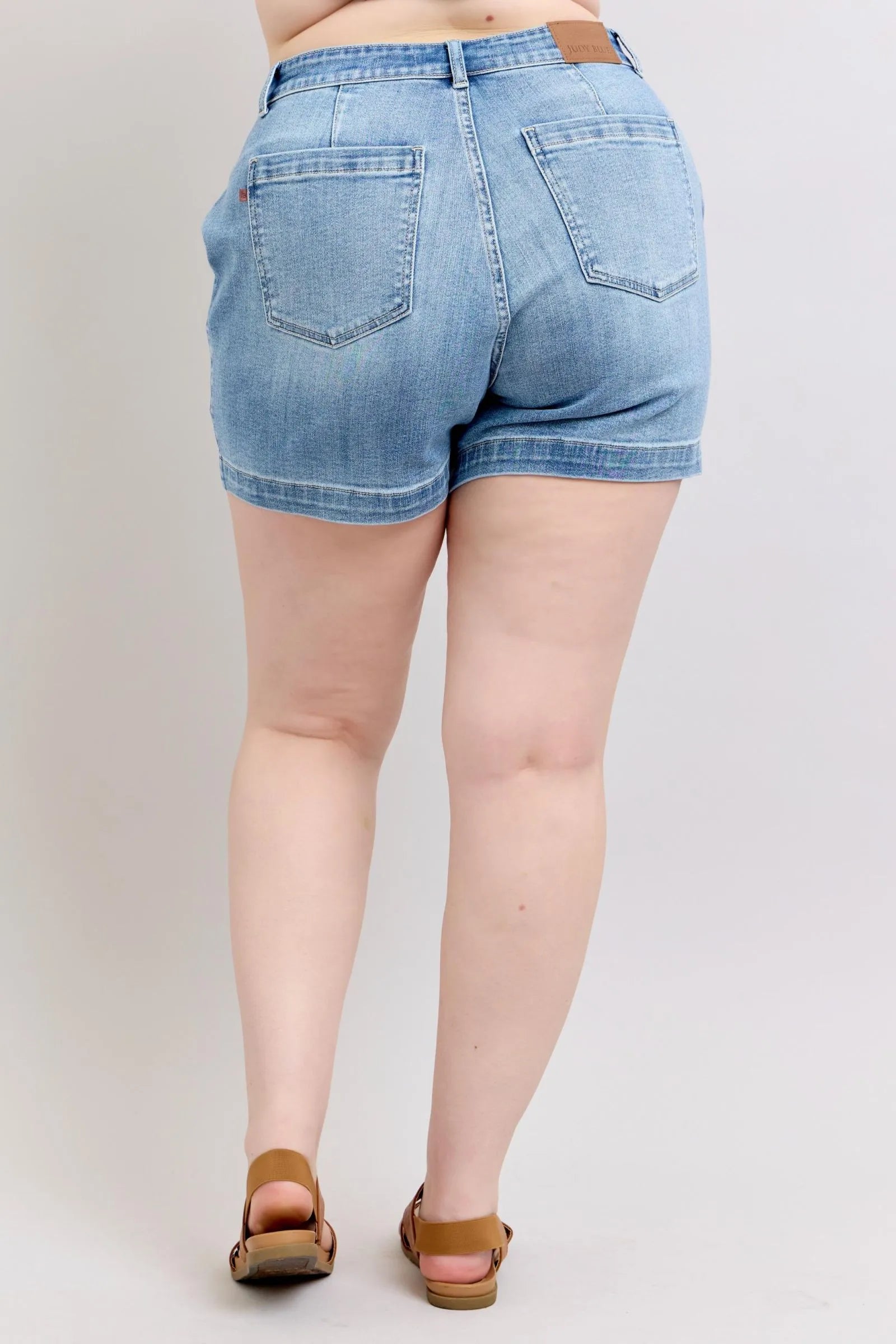 Medium-wash high-rise denim shorts, plus size, back view with belt loops