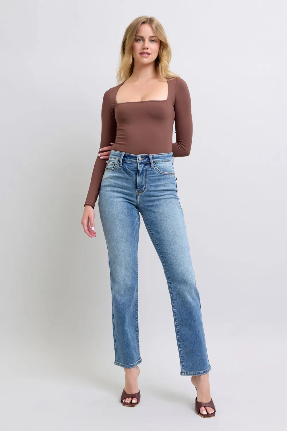 Medium-wash vintage straight jeans with button closure, front pockets, and belt loops