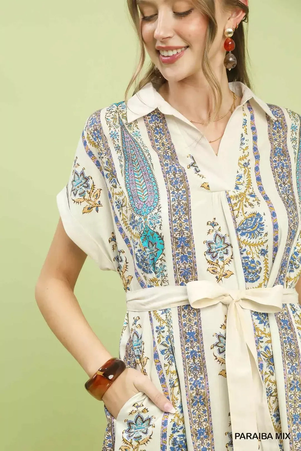 Close-up of tie-waist midi dress bodice, button collar, vertical floral print