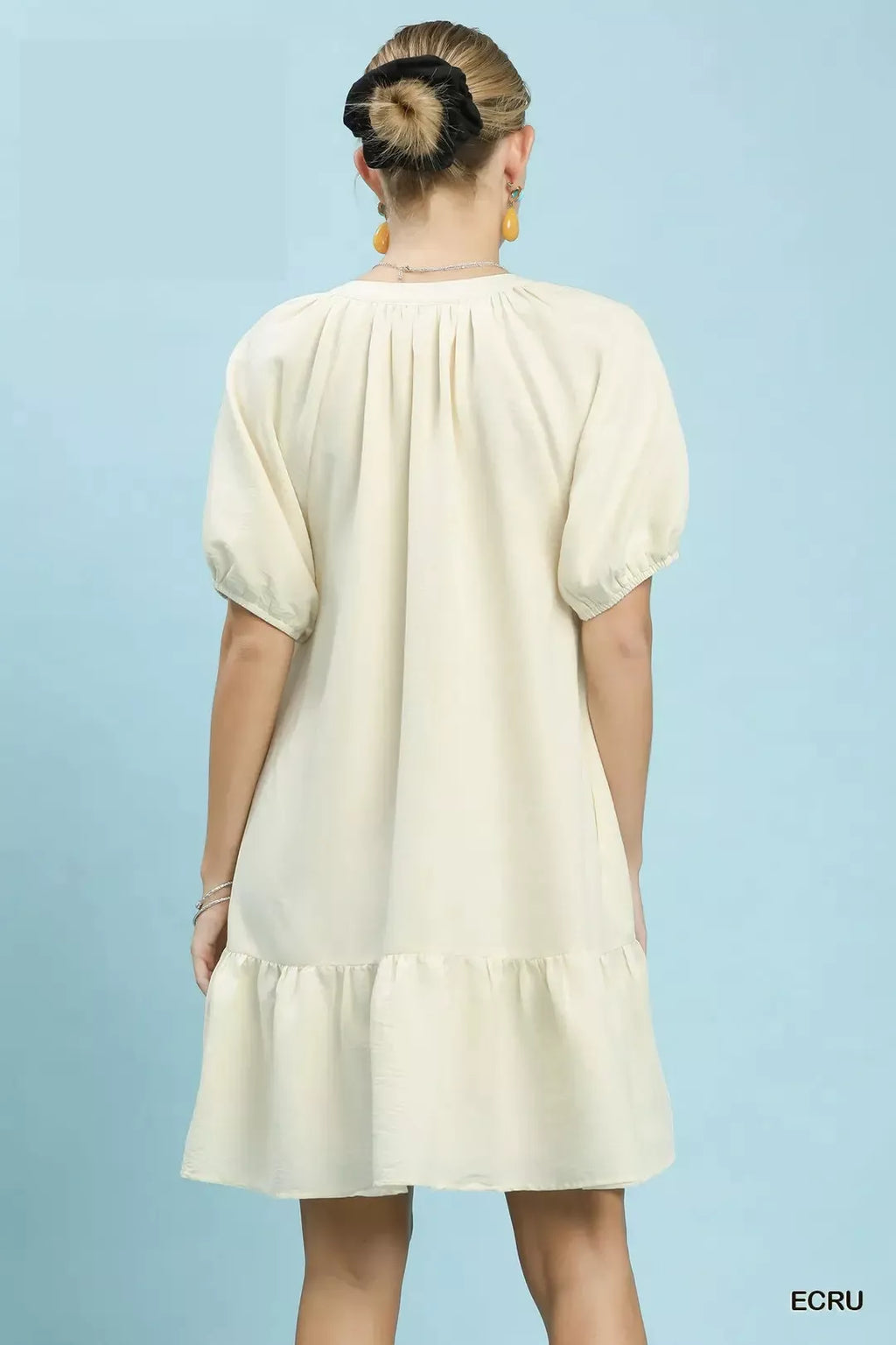 Ecru embroidered floral babydoll dress, back view with puff sleeves and tiered hem