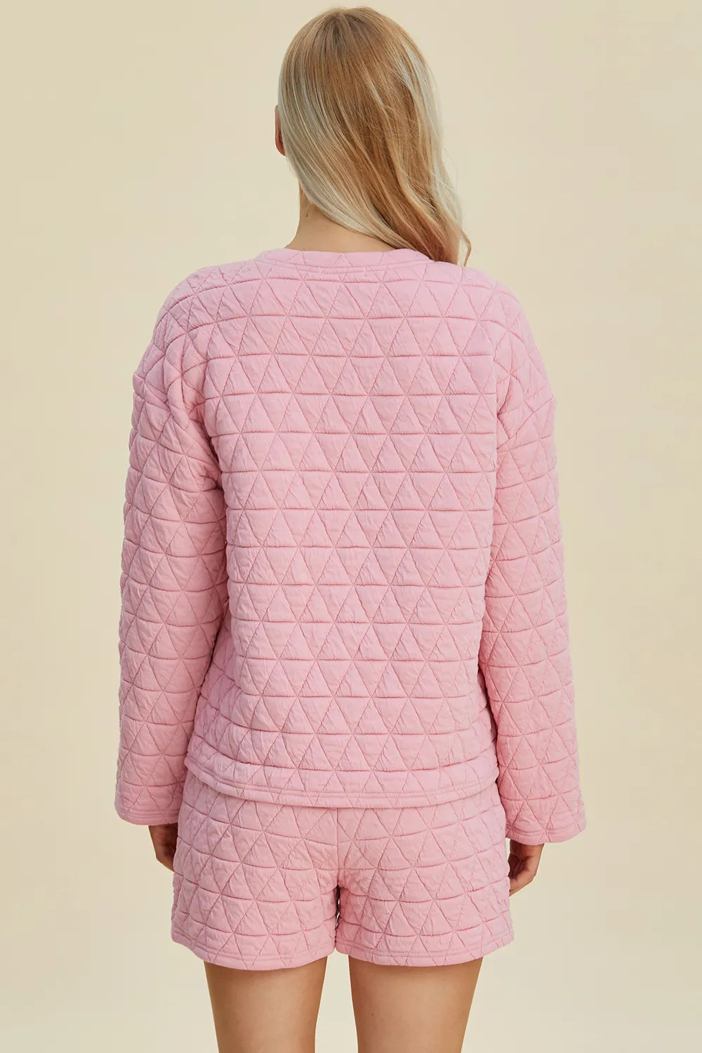 Pink quilted long-sleeve top and shorts set, back view with geometric textured pattern.