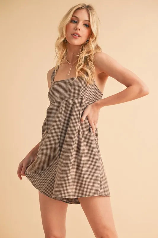 Chocolate plaid square-neck romper with spaghetti straps and gathered waist detail
