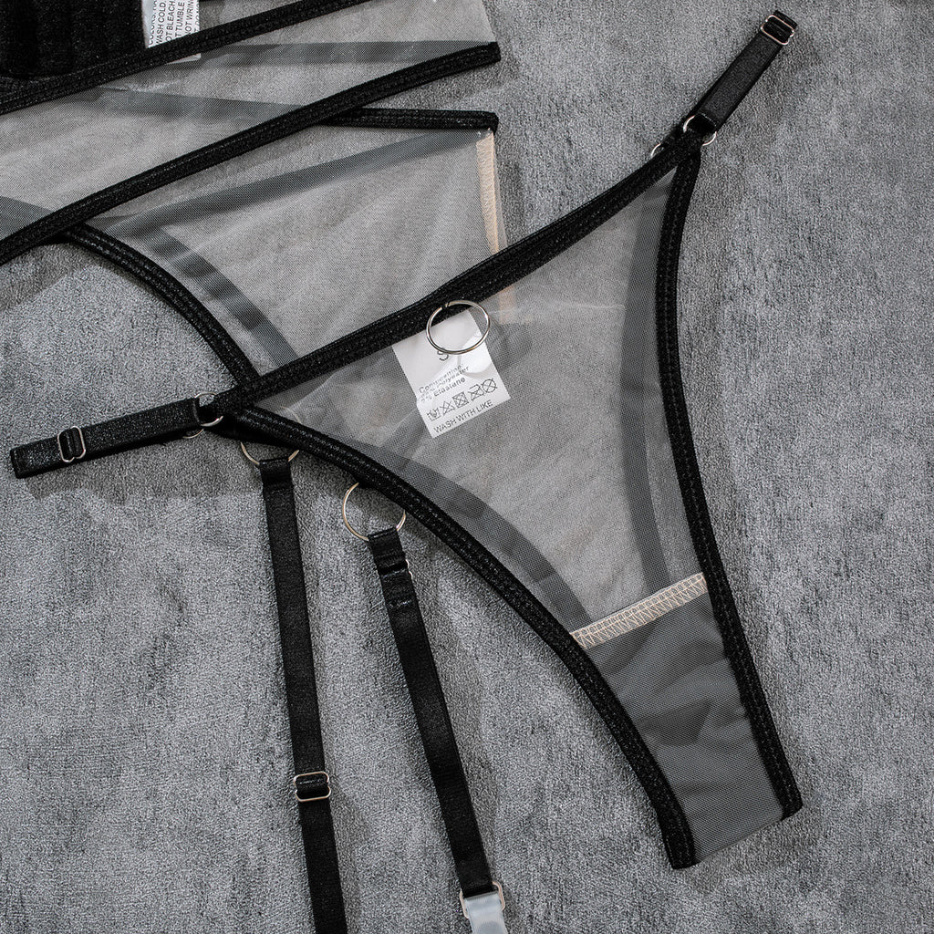 Black mesh underwear straps and garter pieces with metal rings and buckles