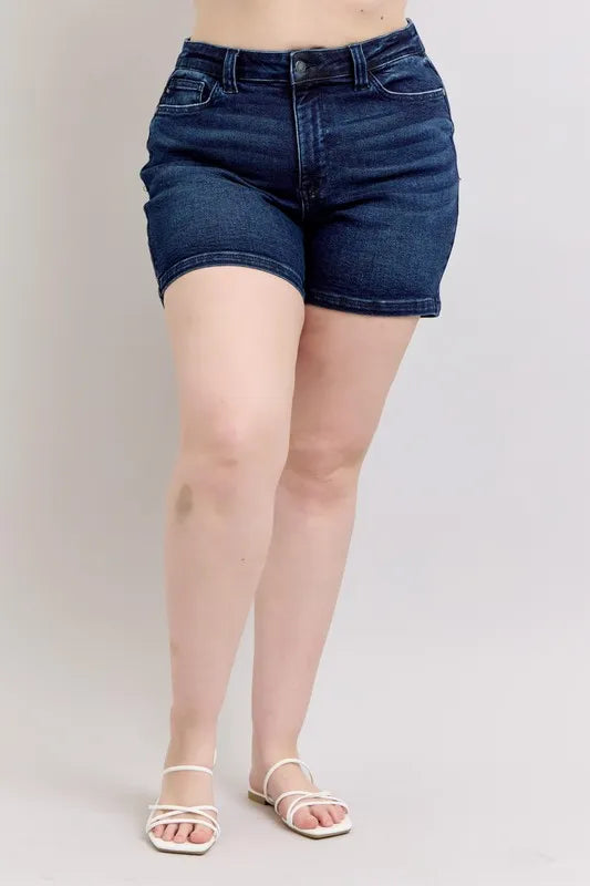 High-waist dark denim shorts, back view with flap pockets