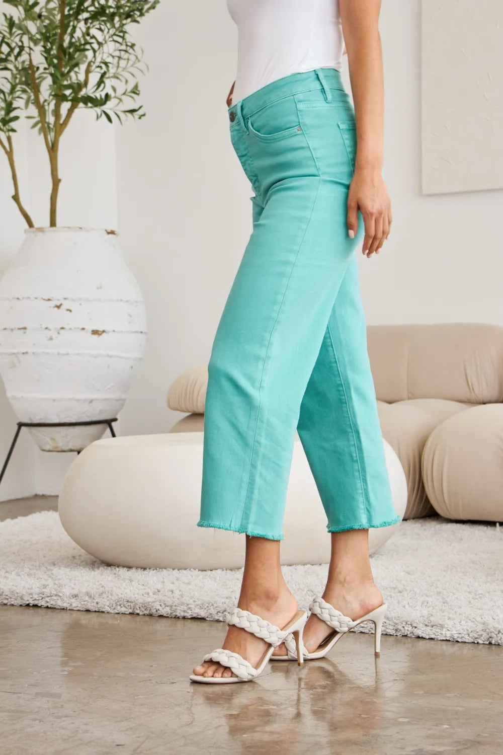 Island Green jeans side view: high waist and raw hem cuff with back seam