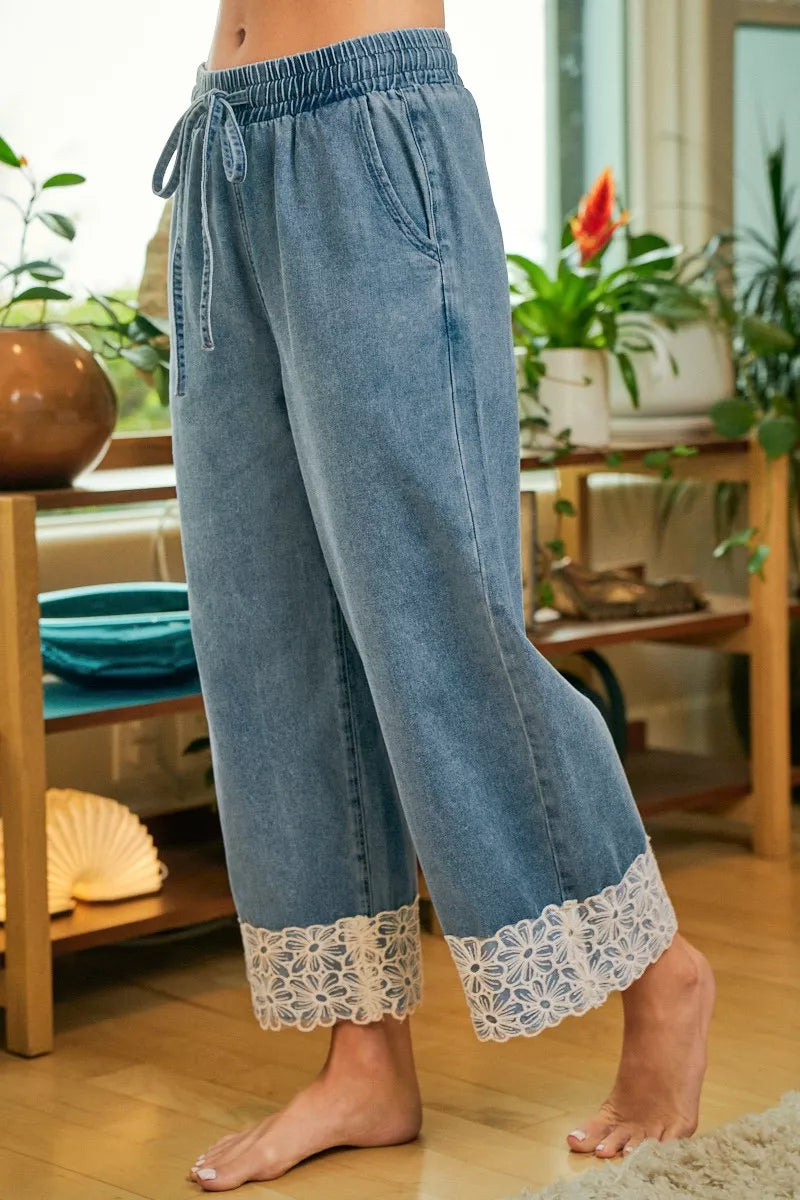 Denim wide-leg pants with elastic waist, drawstring, and flower lace trim along leg hems