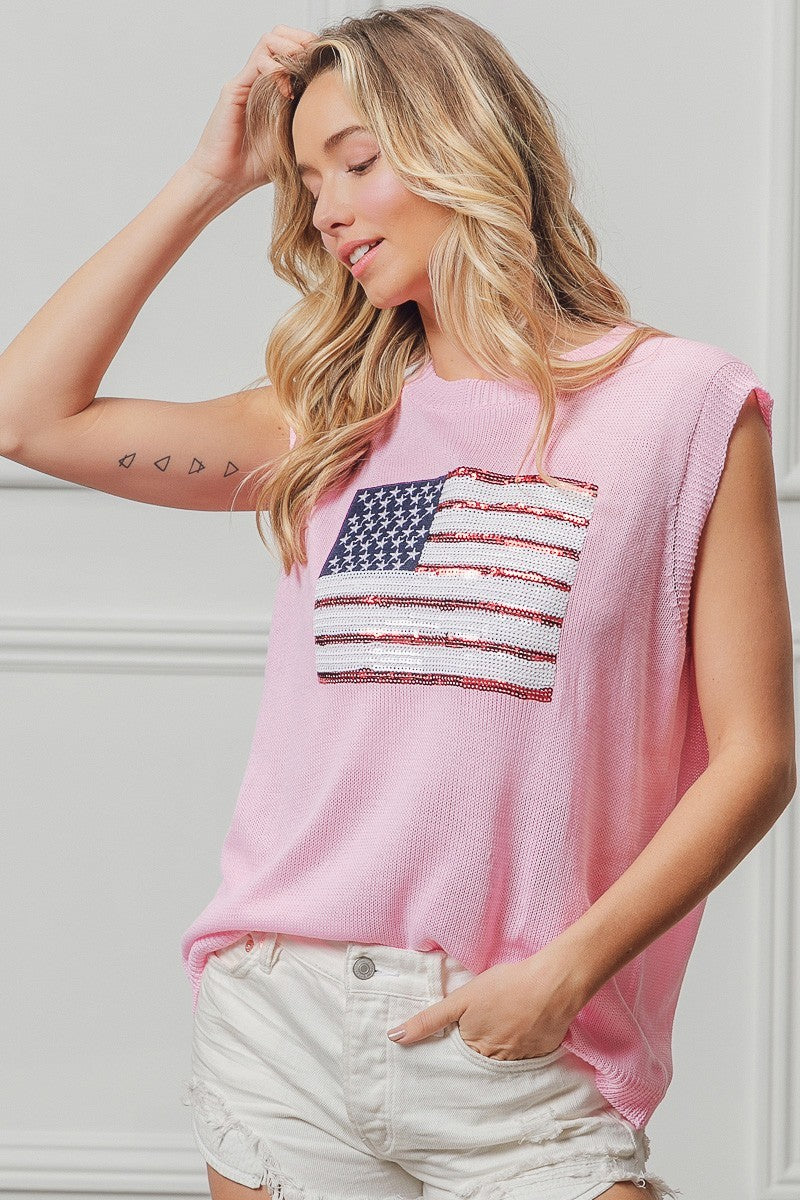 Pink sleeveless knit top featuring American flag sequin patch at center front