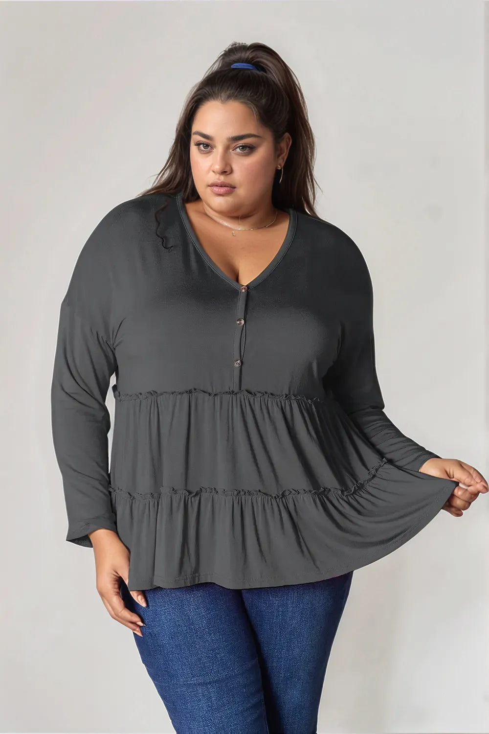 Dark gray long-sleeve blouse with V-neck half-button front and tiered ruffle hem