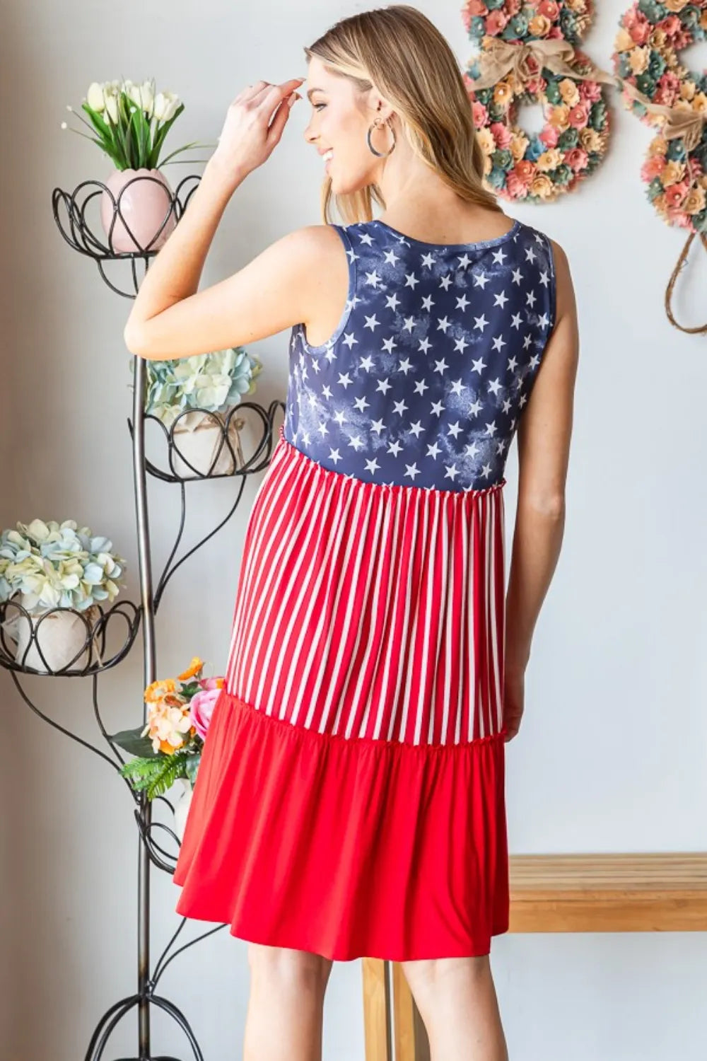 Sleeveless tank dress with blue star print and red striped layers, V-neckline