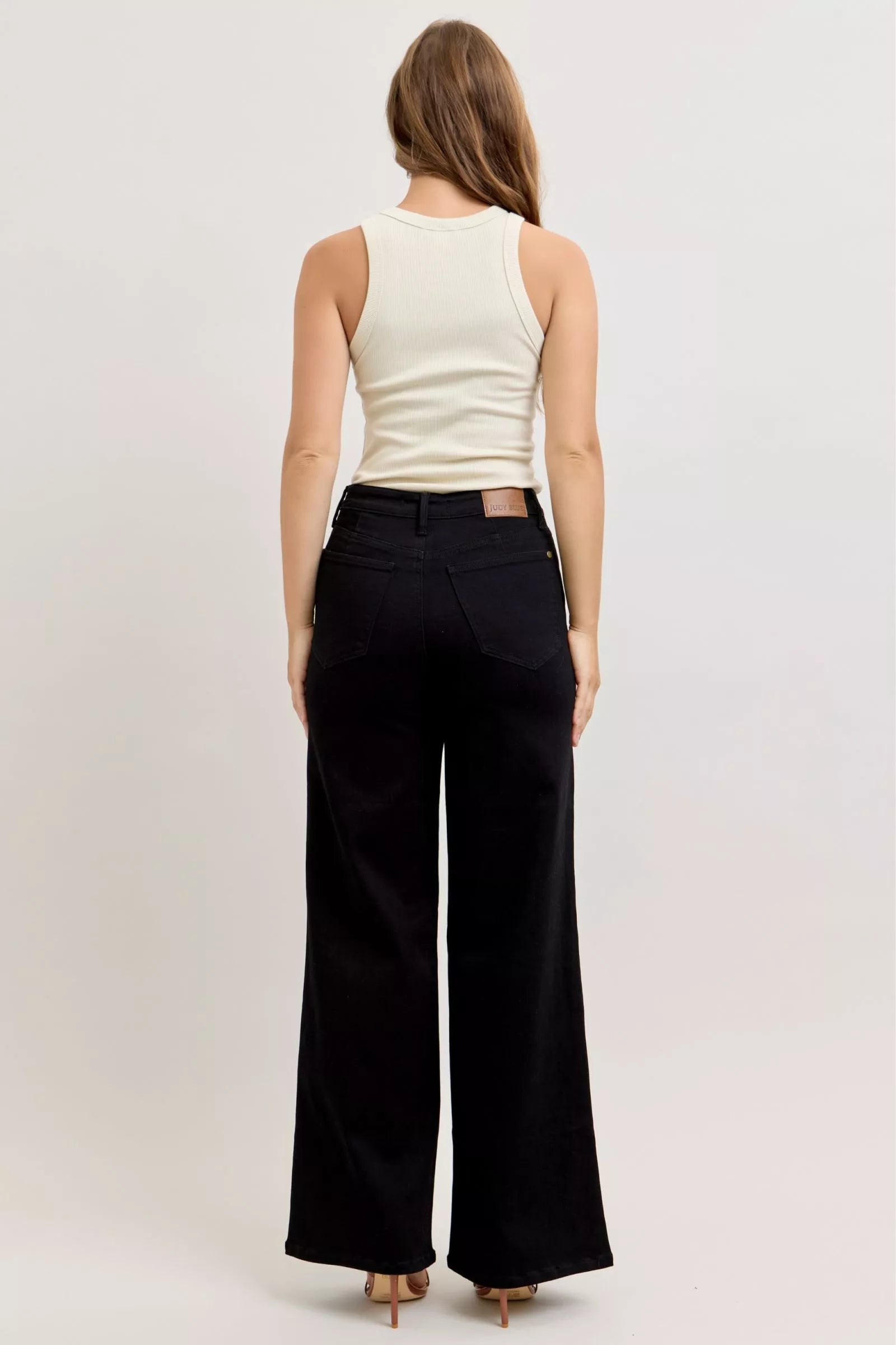 Rear view of black high-waisted wide-leg jeans with belt loops and pockets