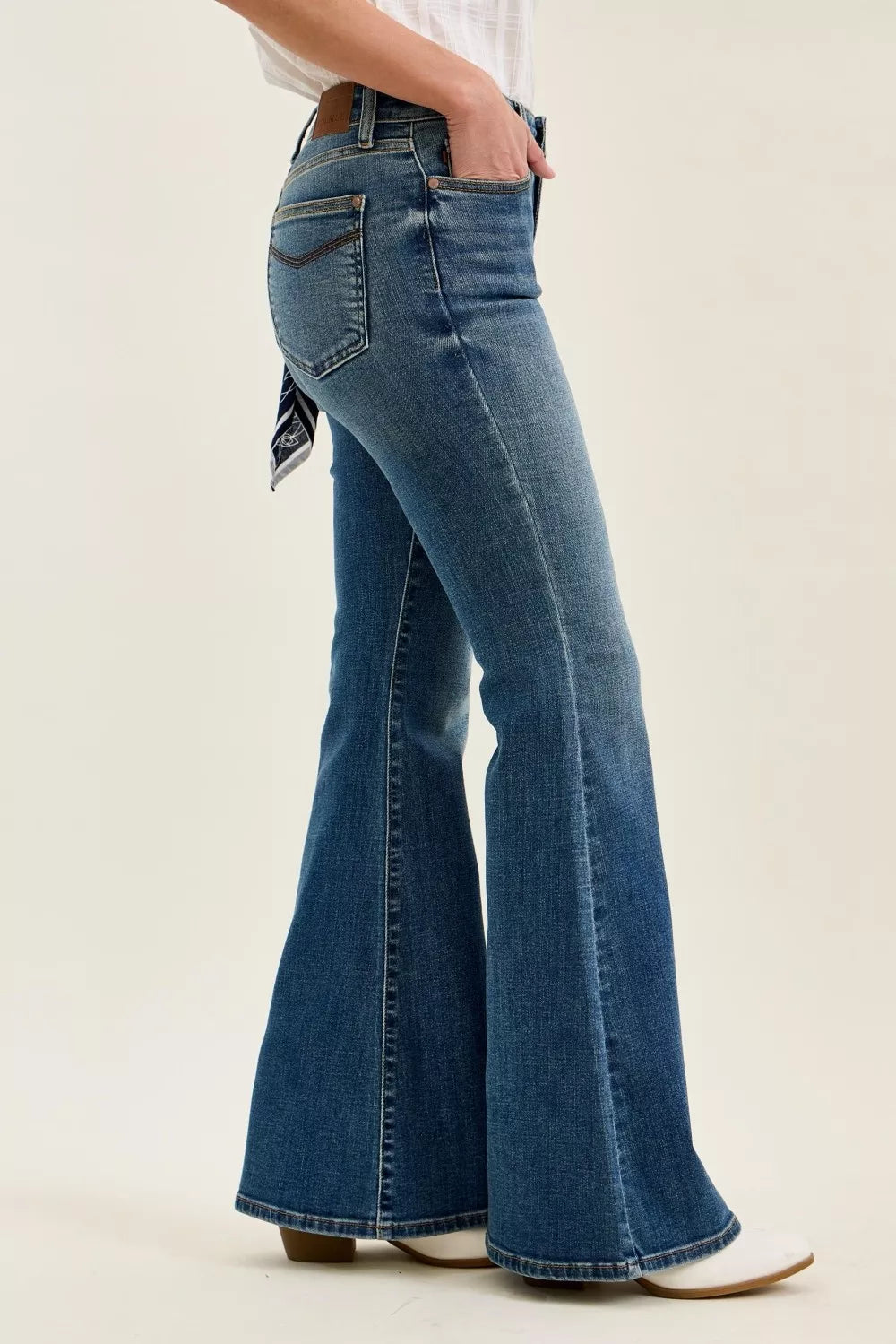 Judy Blue mid-rise flare jeans, side view, wide flared legs and stitched seams