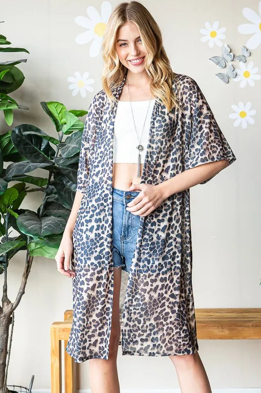 Leopard print open-front cardigan in taupe with short sleeves, worn over denim shorts