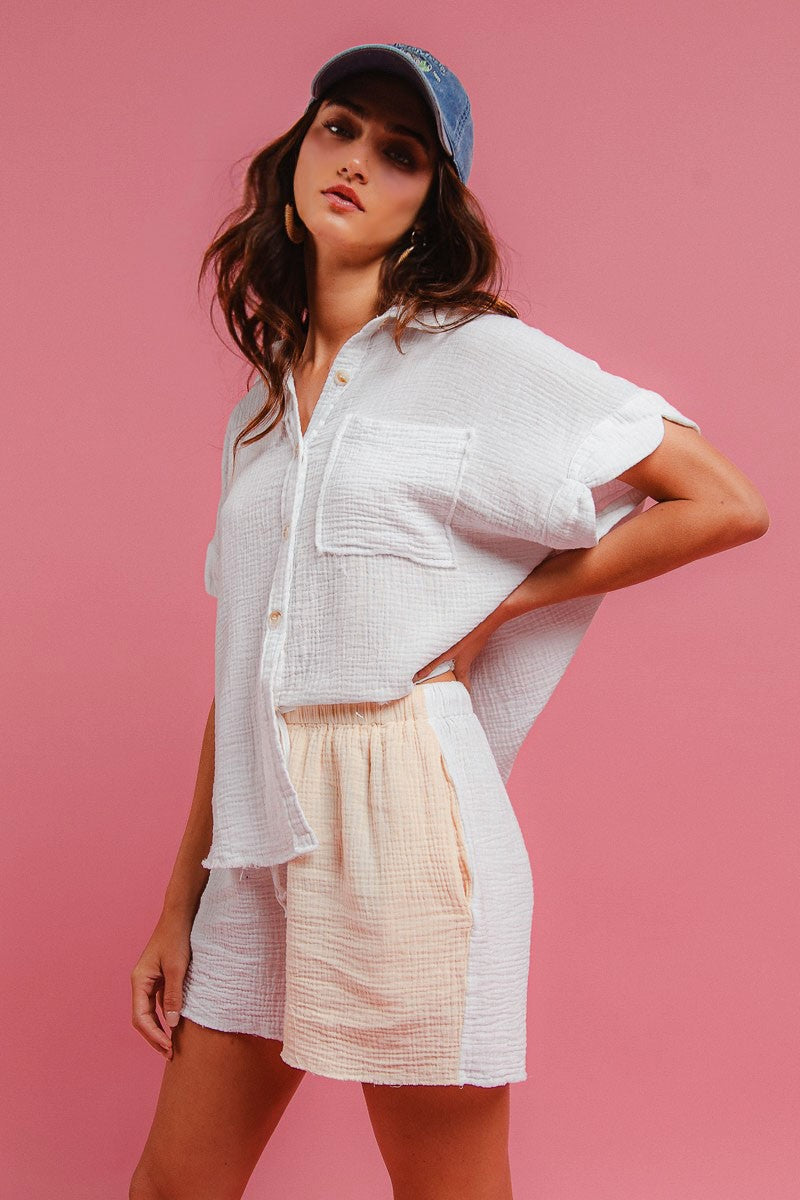 Cream textured gauze top with pocket and button placket, paired with matching shorts