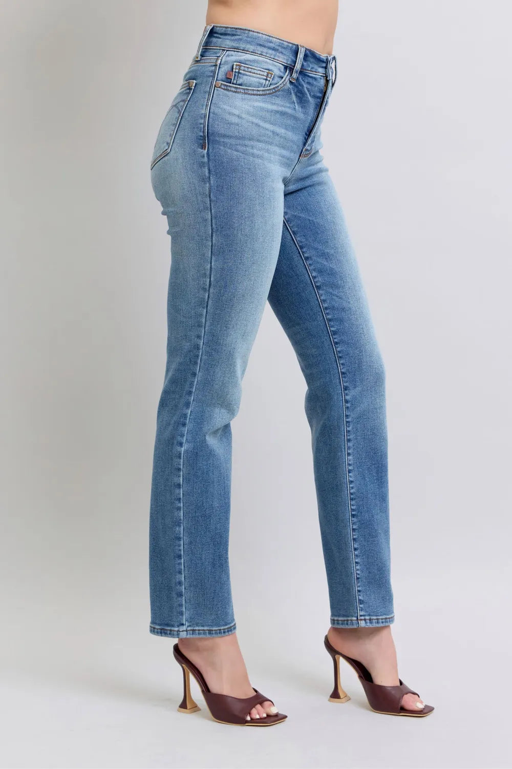 Medium-wash vintage straight jeans with classic front pockets and visible seam details