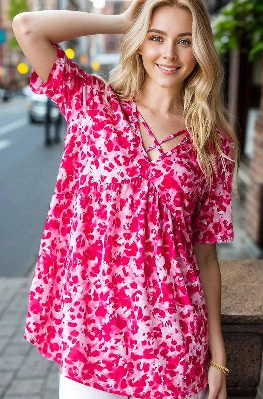 Hot pink animal-print babydoll top with crisscross neckline, short sleeves