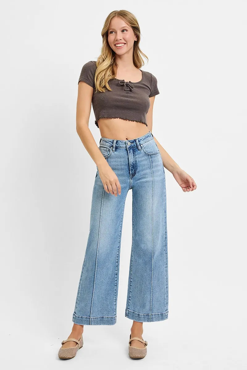 Light-wash high-rise crop wide-leg jeans on model, button fly and belt loops