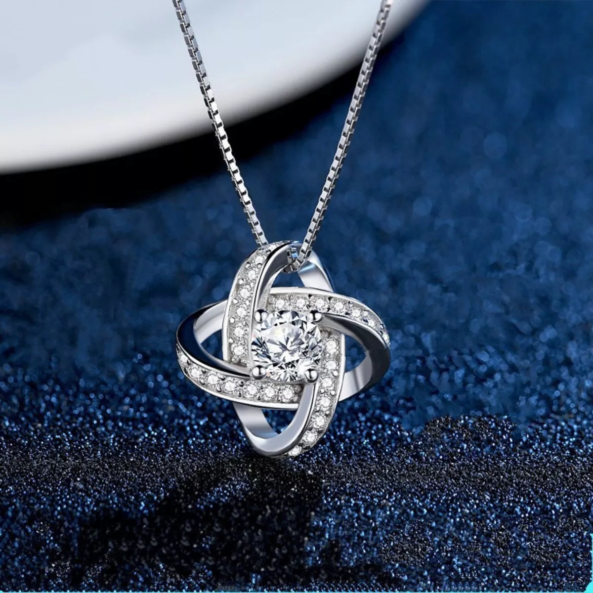 Silver pendant necklace with large round center stone and sparkling halo frame