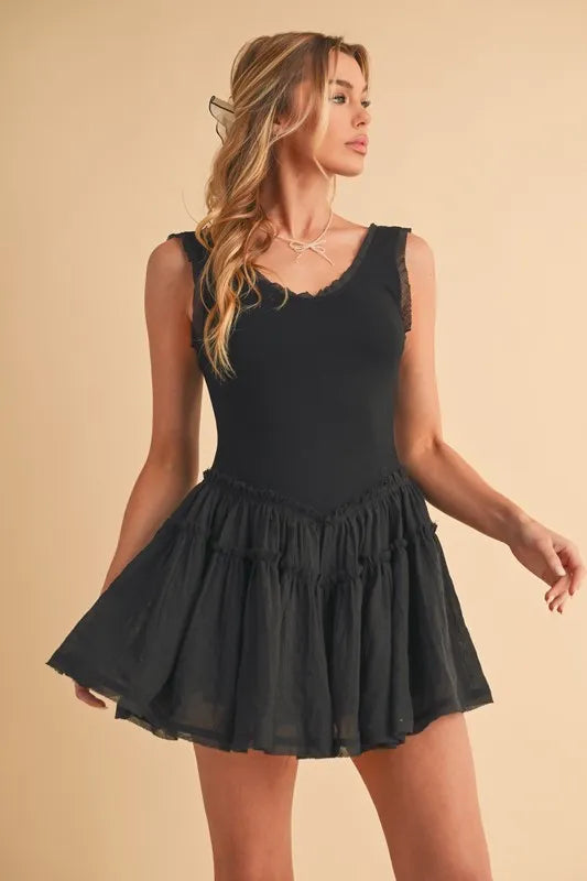 Black sleeveless drop-waist mini dress with full tiered skirt