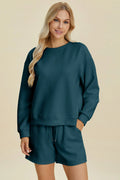 Peacock blue textured long-sleeve crew top and matching shorts set, round neck.