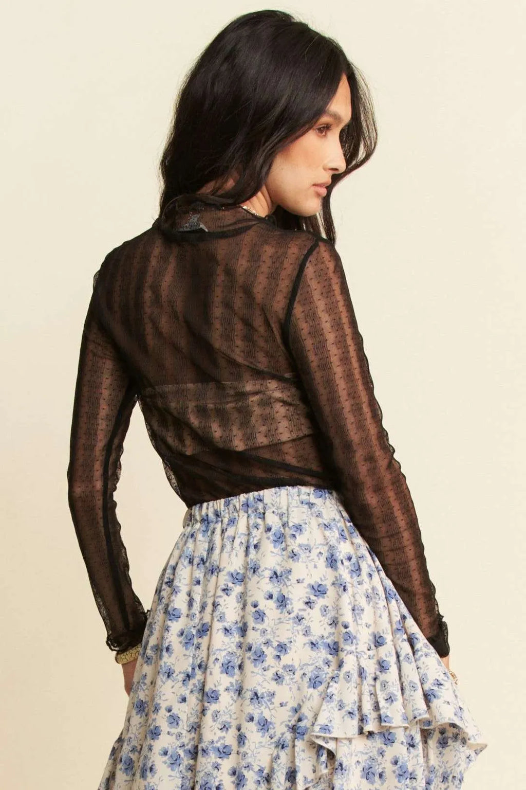 Back view: black sheer dotted mesh turtleneck top with long sleeves