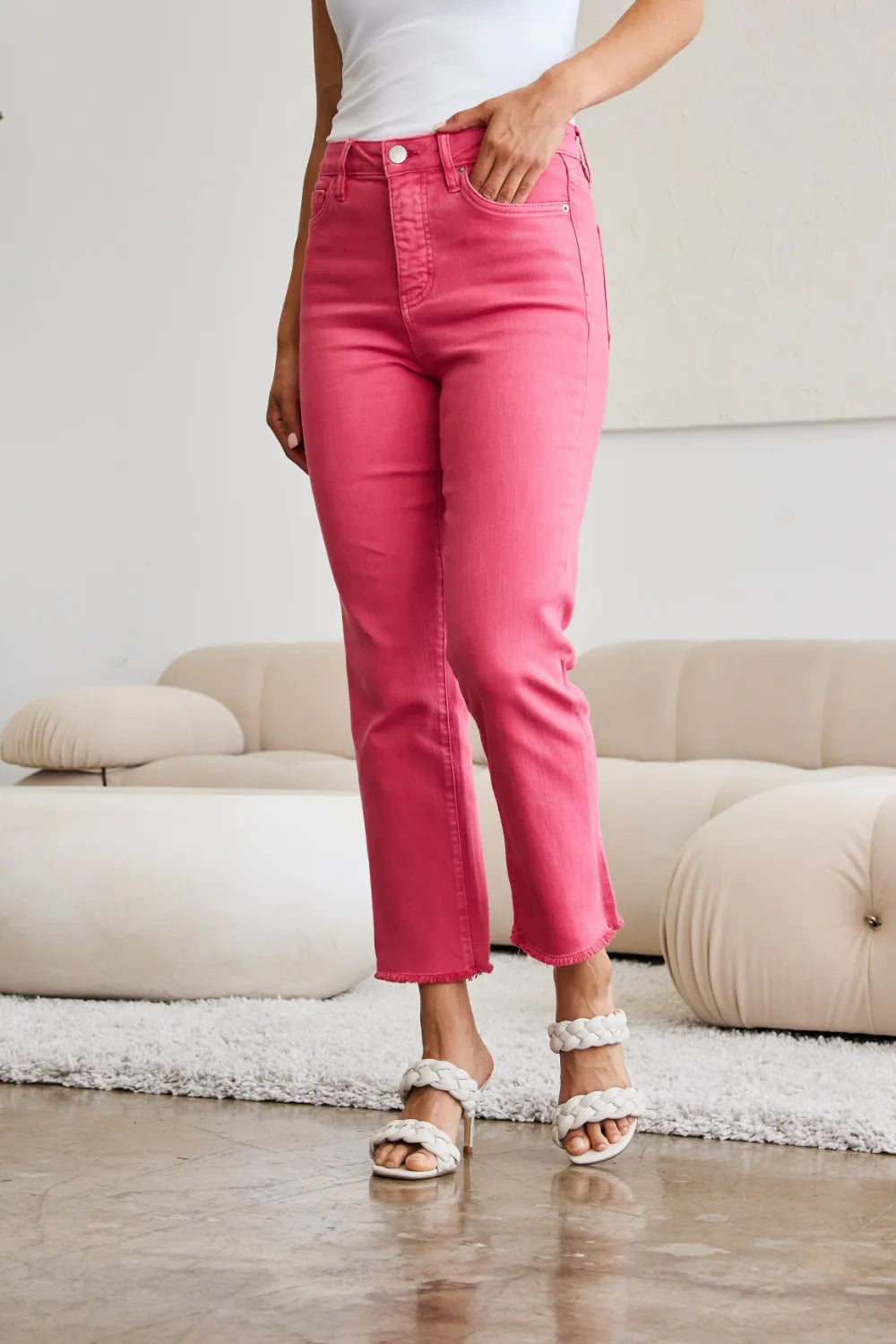 Sunkissed pink high-waist jeans with raw hem and front button closure