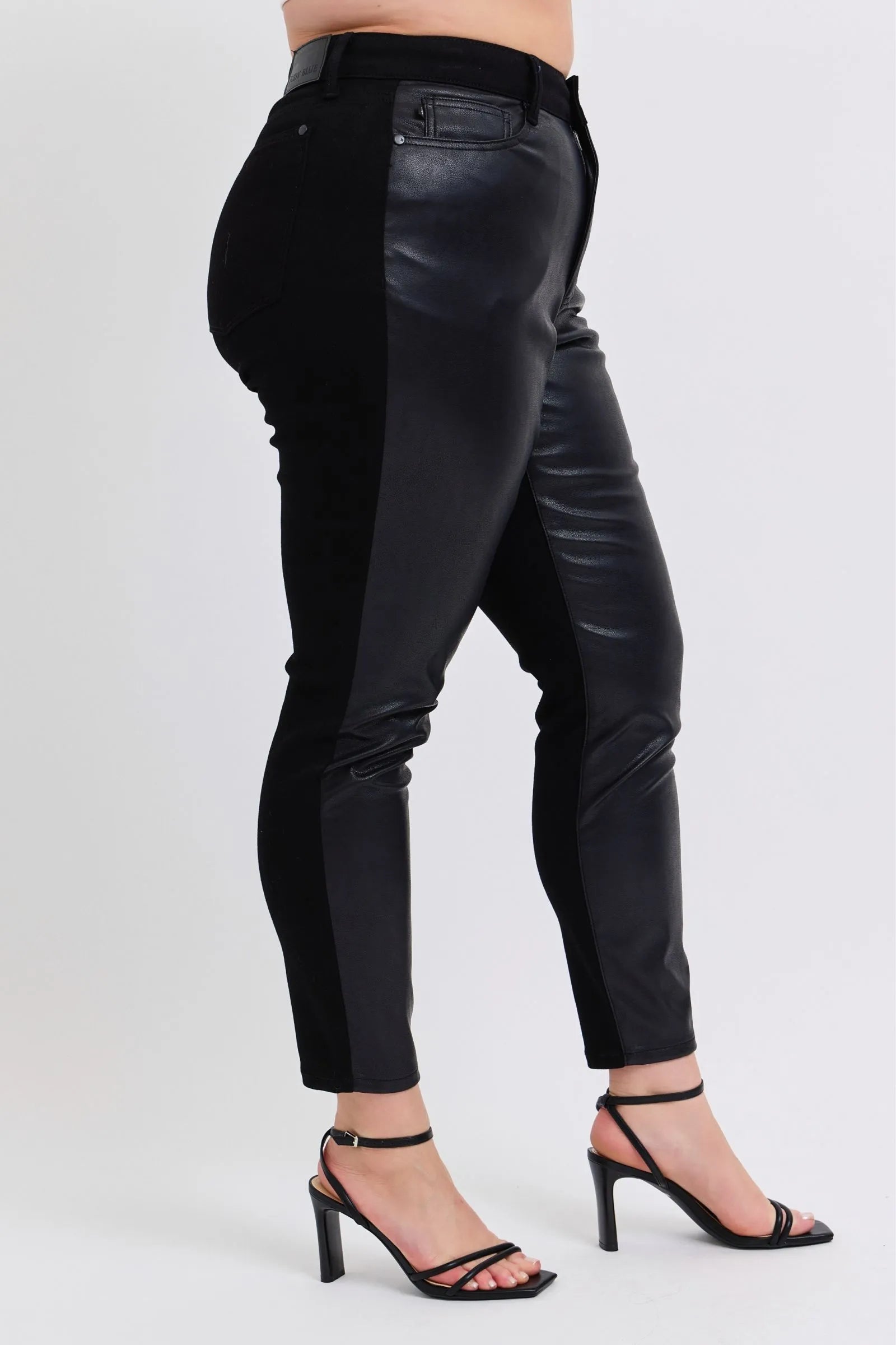Black faux leather skinny pants, back waist detail with pocket stitching and yoke seam