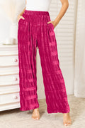 Hot Pink velvet wide-leg pants, high-waist shirring and tiered ruffle panels