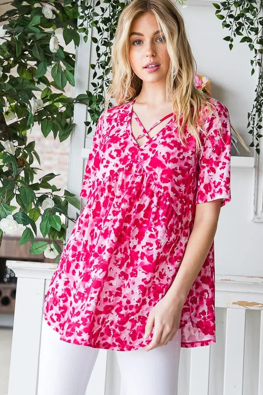 Hot pink crisscross-neck babydoll top with short sleeves and flowy fit