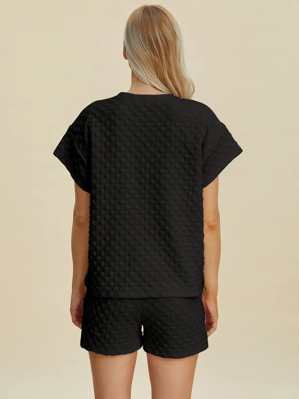 Black textured T-shirt and shorts set, back view showing crew neck and full shorts.