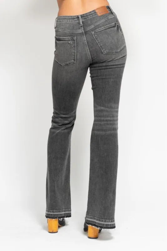 Washed gray mid-rise flare jeans, back three-quarter view with frayed release hem