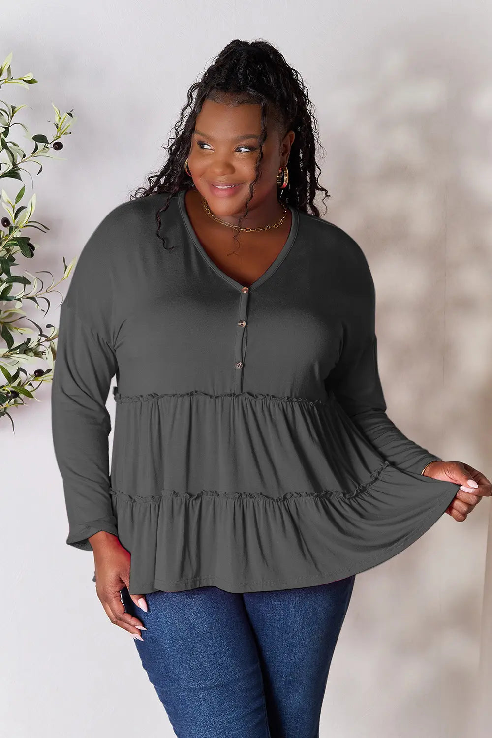 Dark gray long sleeve blouse with half-button front and ruffle hem