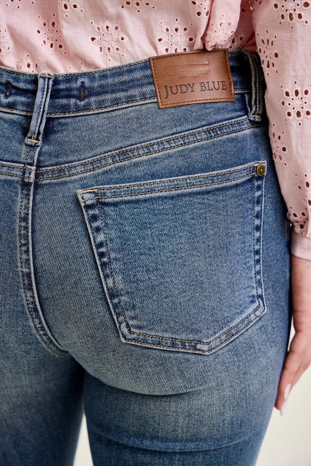 Front flap pocket detail on mid-rise flare jeans in dark wash, Judy Blue patch