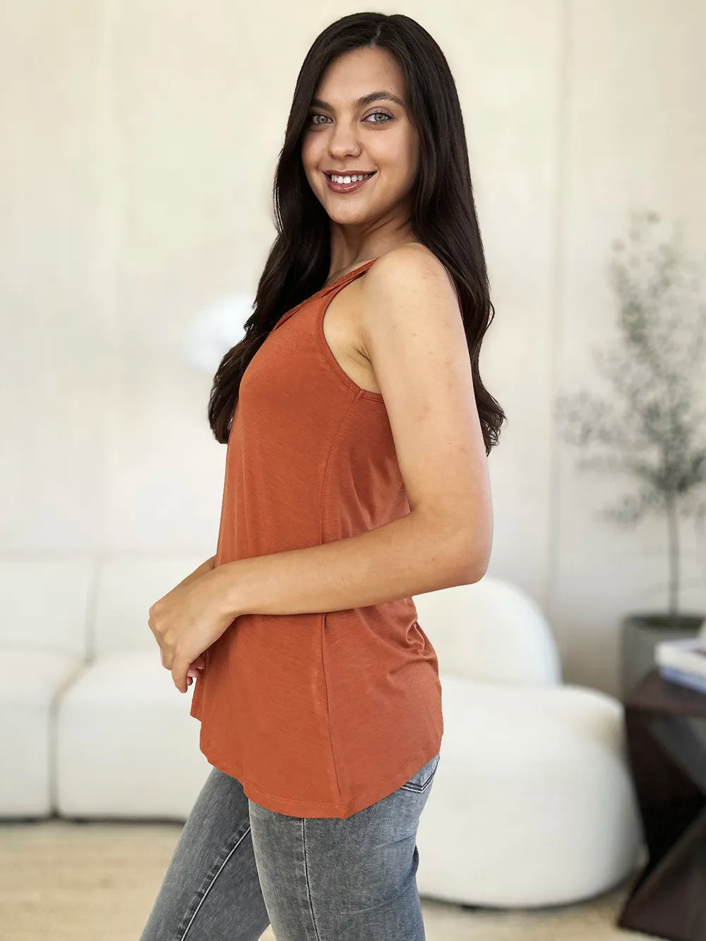 Rust orange camisole side view with lace-trimmed neckline and curved hem