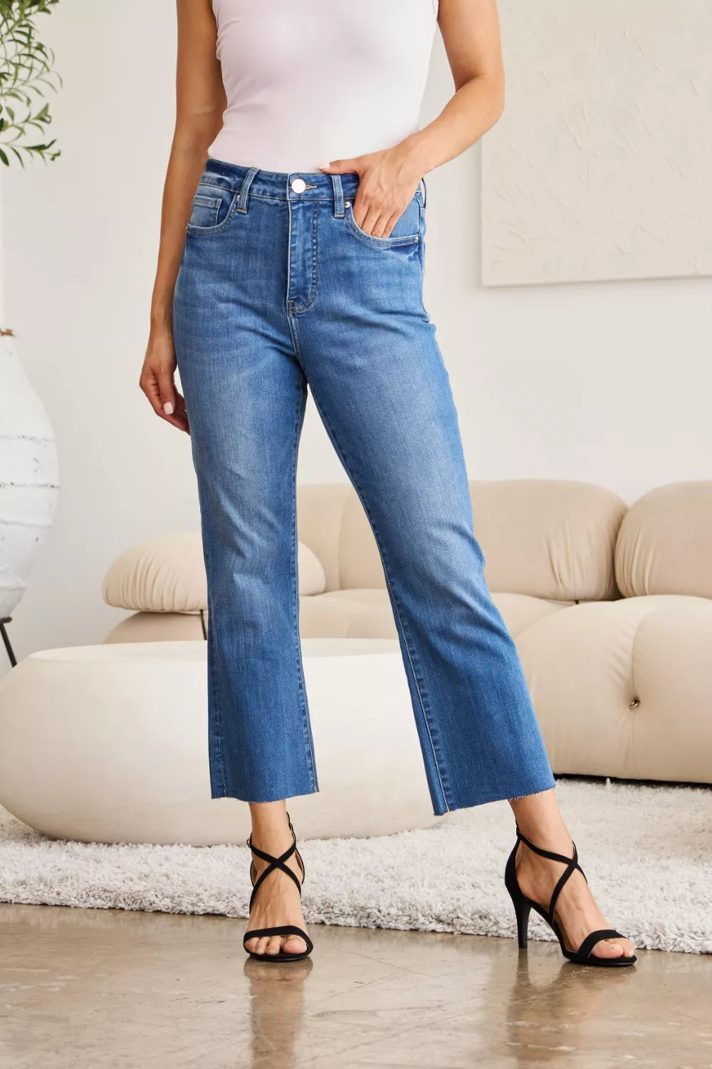 Medium blue high-waist tummy-control jeans with classic 5-pocket styling and cropped flare leg