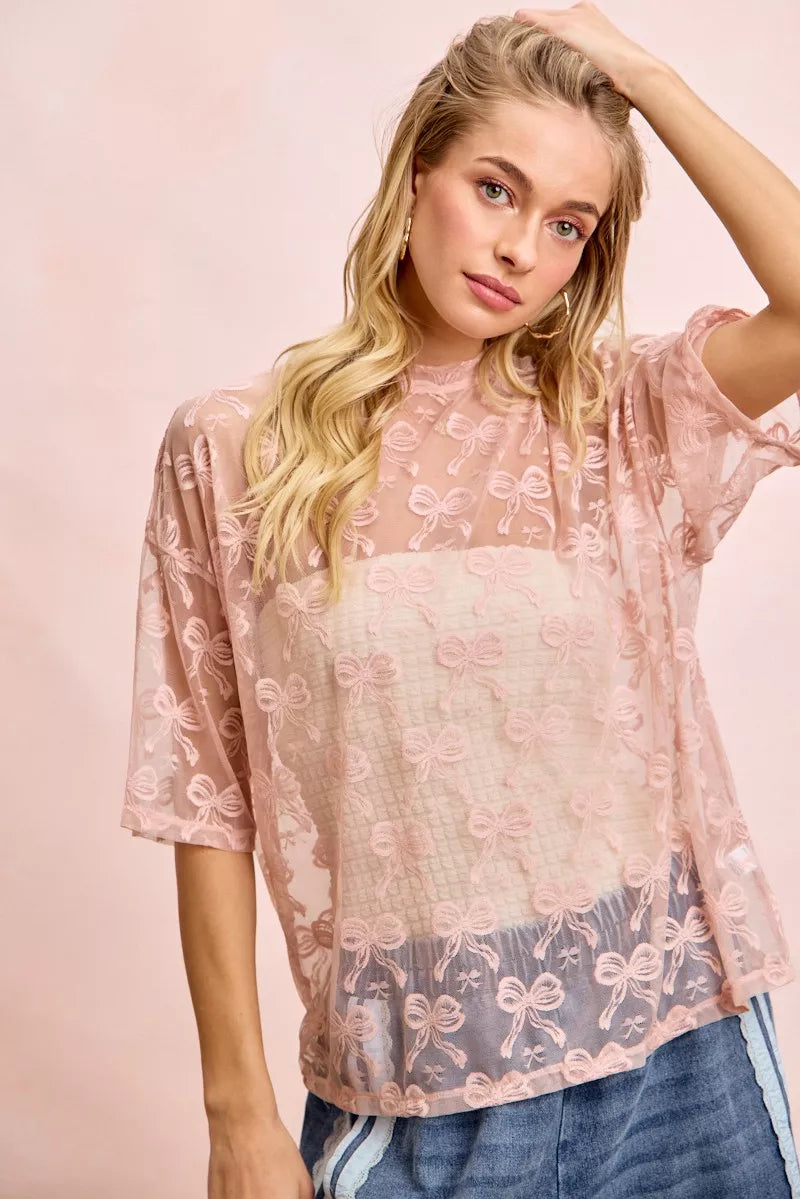 Dusty rose semi-sheer mesh top with bow print, boxy fit and short sleeves