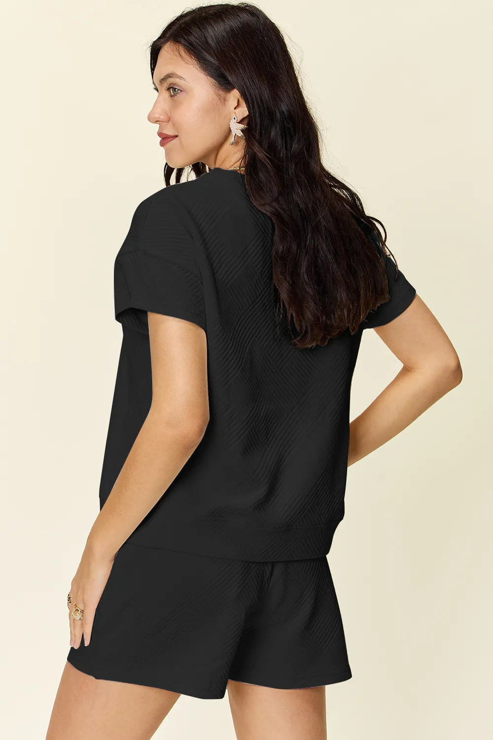Black textured T-shirt and drawstring shorts set, side view of short sleeves
