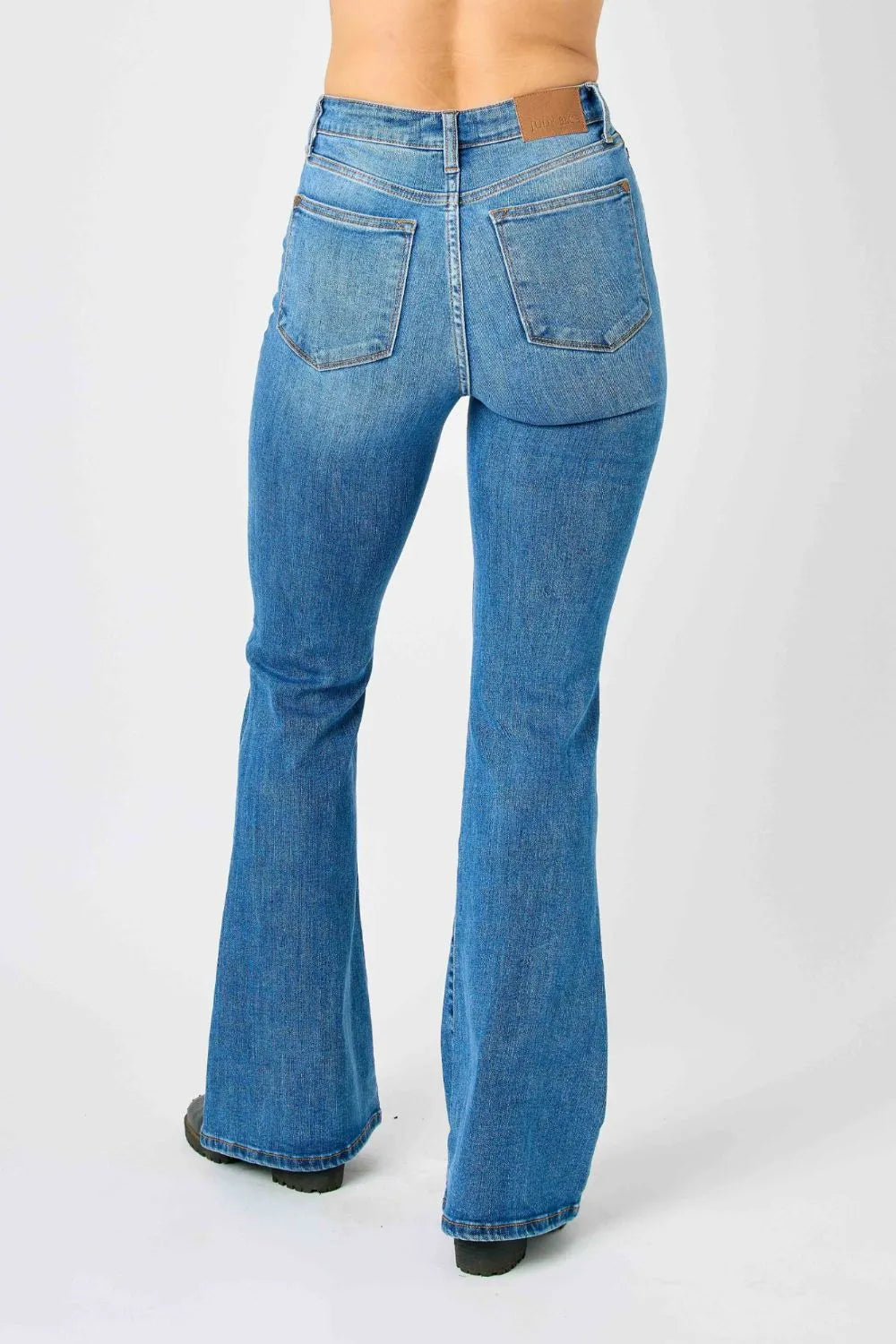 Rear view of medium-blue high-waisted flare jeans with yoke and back pockets