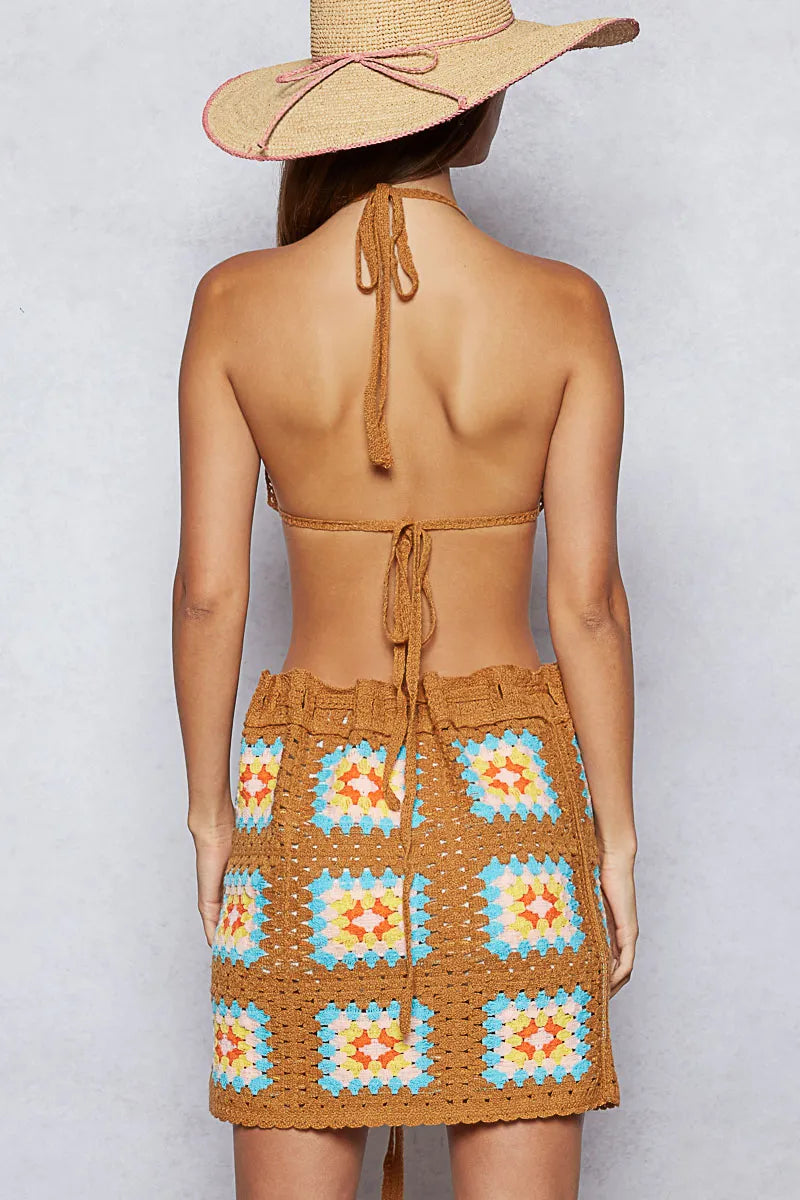 Back view: open-back crochet halter cami with tied straps and mini skirt set