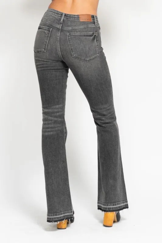Washed gray mid-rise flare jeans, back view with two back pockets and frayed hem