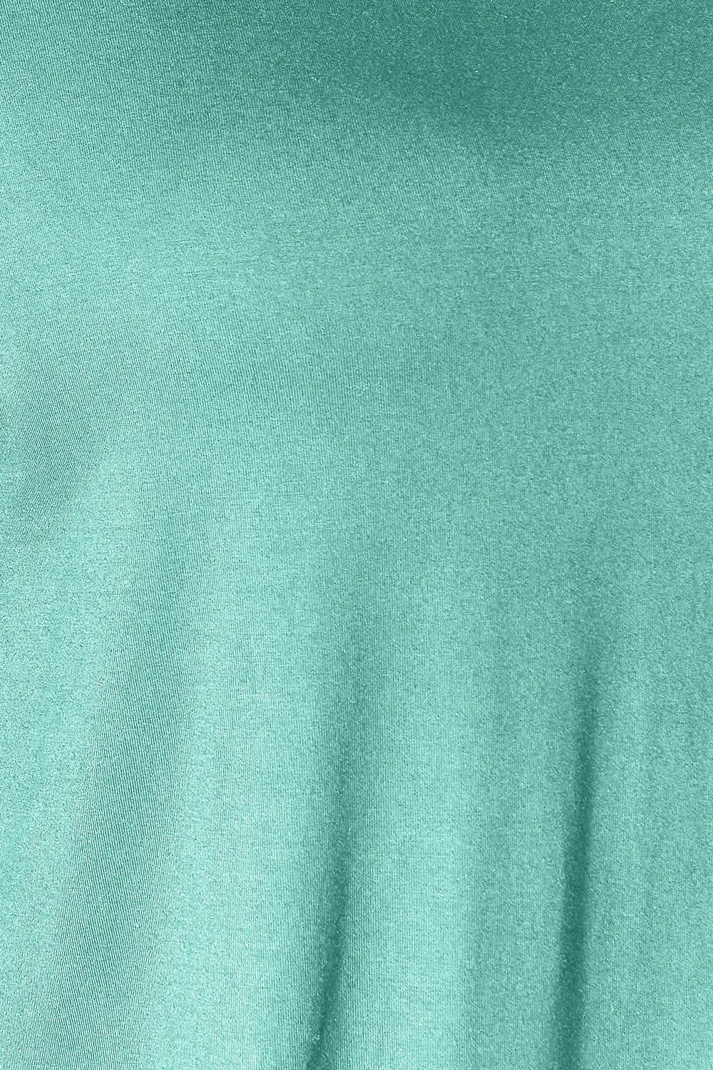 Close-up fabric texture in teal for the slit top and pants set