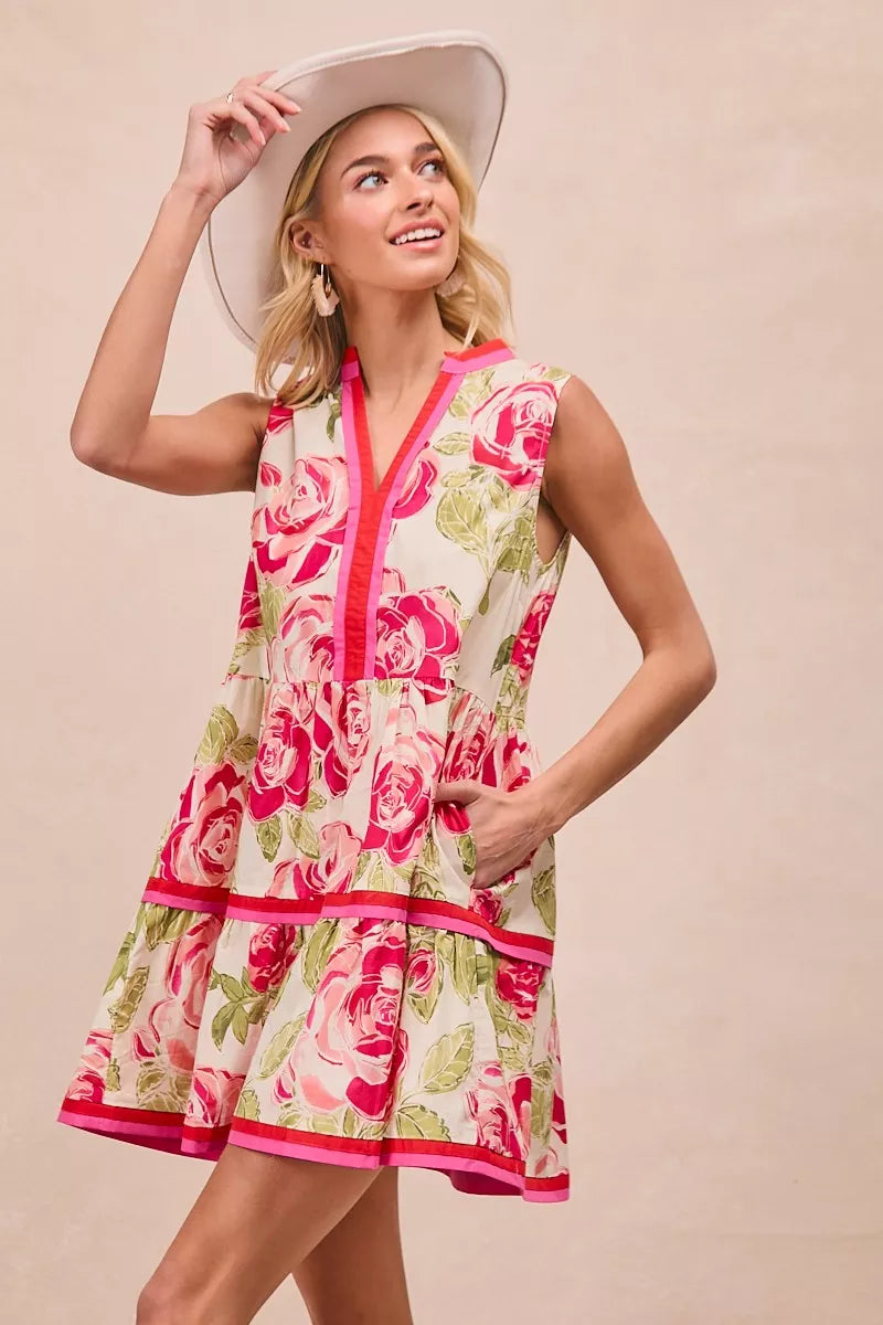 Floral woven mini dress with contrast pink V-neck trim and tiered skirt panels