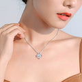 Silver moissanite pendant necklace with four-leaf clover charm and round center stone