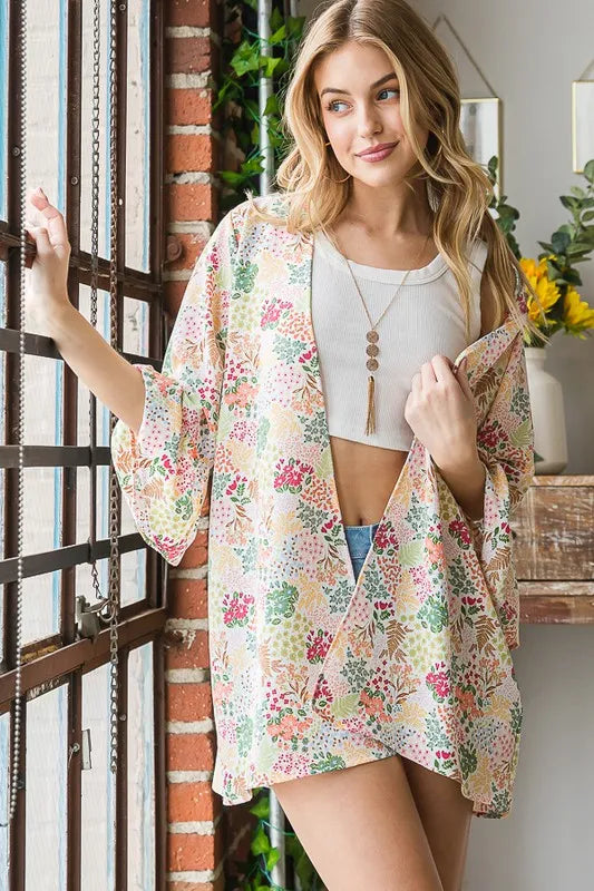 Ivory multi floral open cardigan over white top, front view