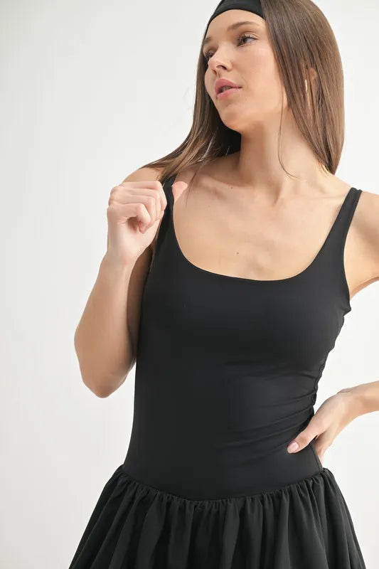 Black tank mini dress close-up, scoop neckline and gathered waist on flared skirt